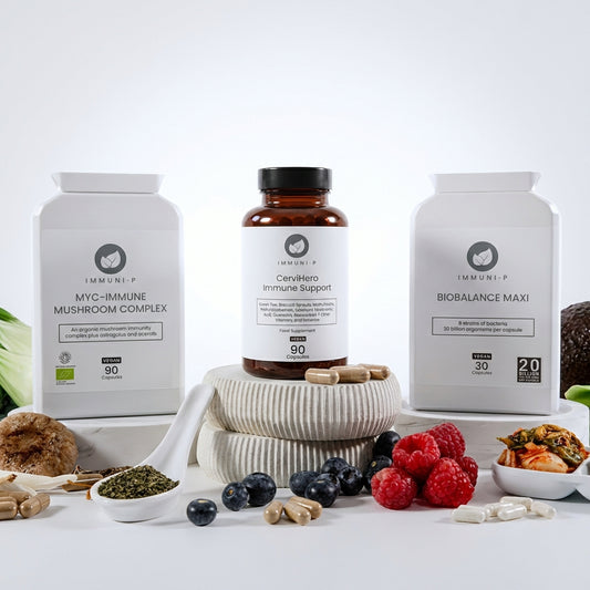 Supplement products on a white surface with fresh fruits and vegetables.