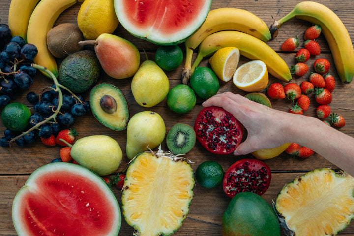 Colorful variety of fresh fruits like watermelon, pineapple, banana, and pomegranate to support immune health
