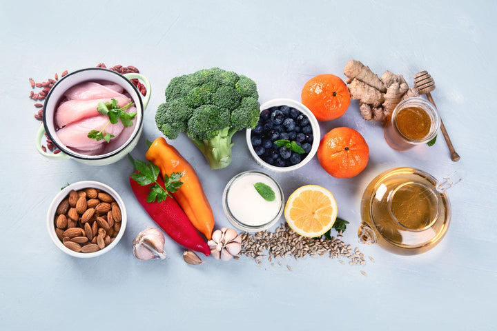 Flat lay of immune boosting foods including vegetables, fruits, nuts, and anti-inflammatory spices.