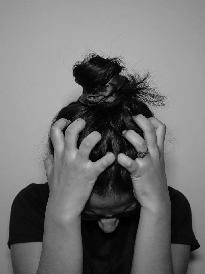 Black and white photo of someone feeling stressed and anxious  