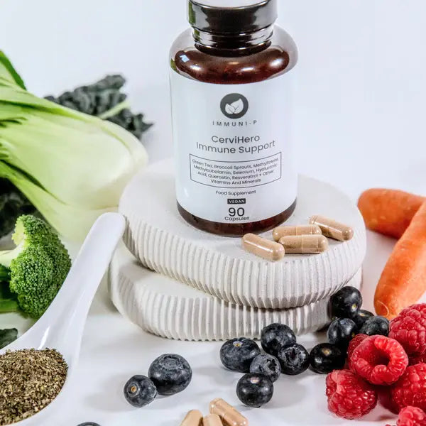 CerviHero Immune Support supplement bottle surrounded by vegetables and fruits on a white background for immune and cervical health support
